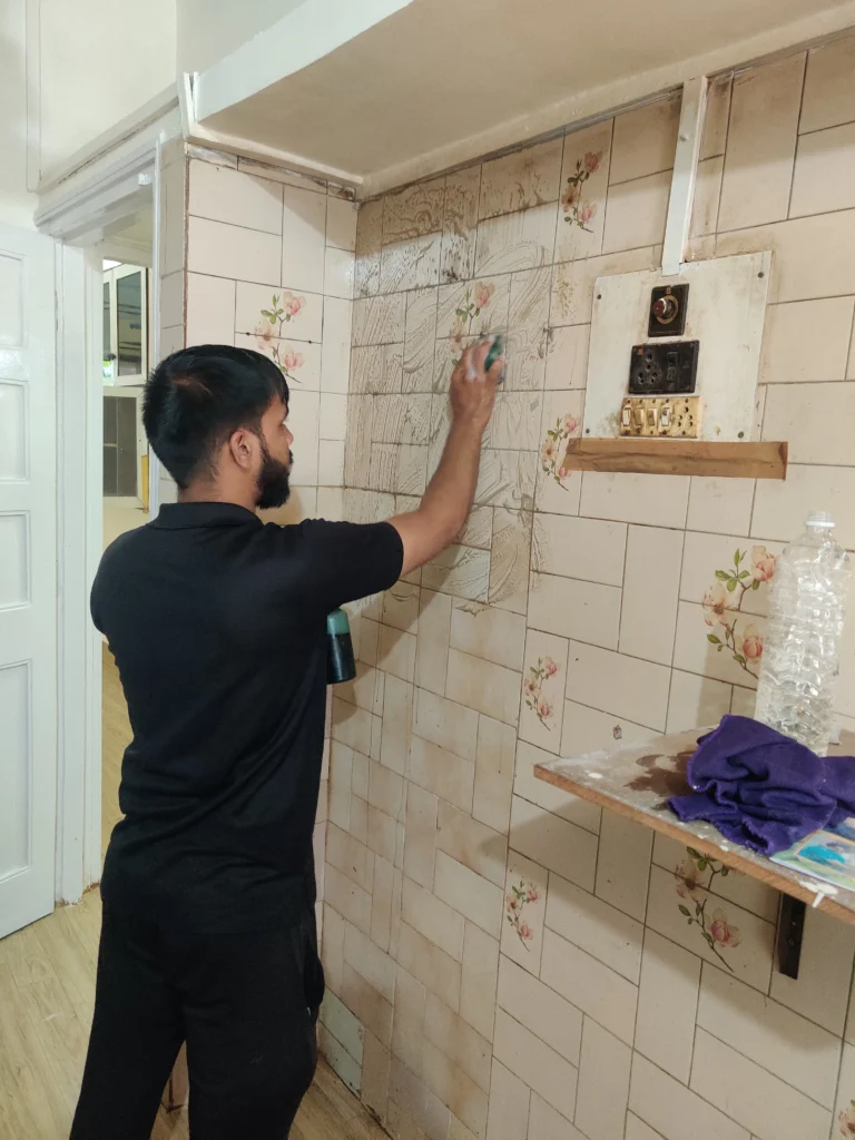Professional house cleaning staff in Mumbai cleaning kitchen and floor areas
